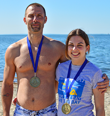 father and daughter with medals at the 2014 Buzzards Bay Swim