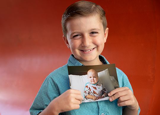 Pierce holding a picture of himself as a baby.