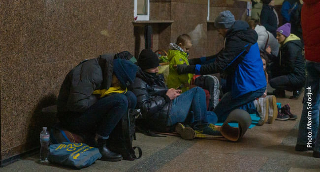 A man comforts a child at the train station in Ivano-Frankivsk, Ukraine.