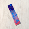 Purple, mauve, and pink epoxy resin mezuzah cover with blue metallic flakes