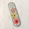 Clear epoxy resin mezuzah cover with three colours of dried flowers