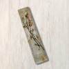Clear epoxy resin mezuzah cover with delicate flower and gold and silver leaf