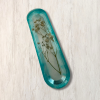 Turquoise and clear resin mezuzah cover with dried baby's breath flowers