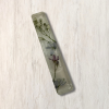Clear epoxy resin mezuzah cover with delicate purple, blue, and white flowers