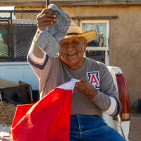 A photo of Native Elders holding their Holiday stockings