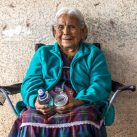 A photo of a a Native Elder with water