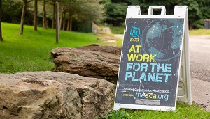 Image of SCA sign that says At Work for the Planet